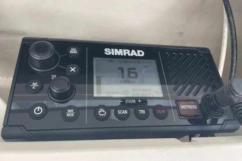Slide: The Image of Simrad marine radio on 2023 Robalo R270 Center Console, displaying channel 16 distress signal. - 16