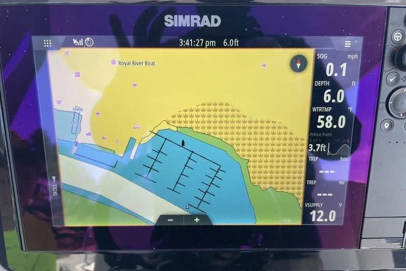 Slide: The Image of Simrad navigation display on 2023 Robalo R270 Center Console boat, showing map and data. - 18