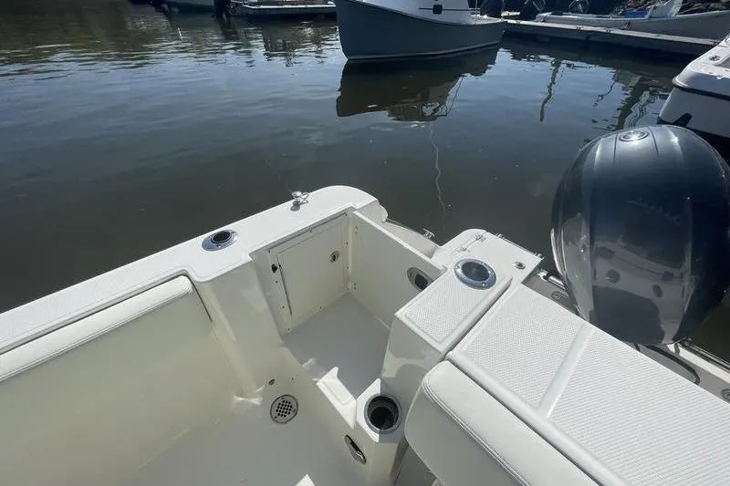 Slide: The Image of 2023 Robalo R270 Center Console boat interior with seating and engine view. - 26