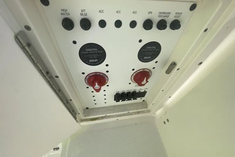 Slide: The Image of 2023 Robalo R270 Center Console control panel with switches and dials. - 27