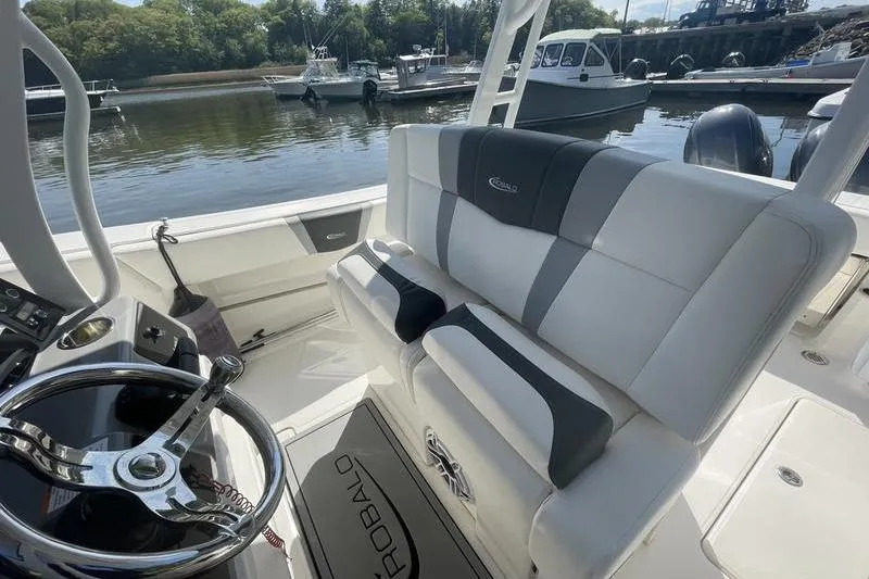 Slide: The Image of 2023 Robalo R270 Center Console boat interior with steering wheel and seating. - 9