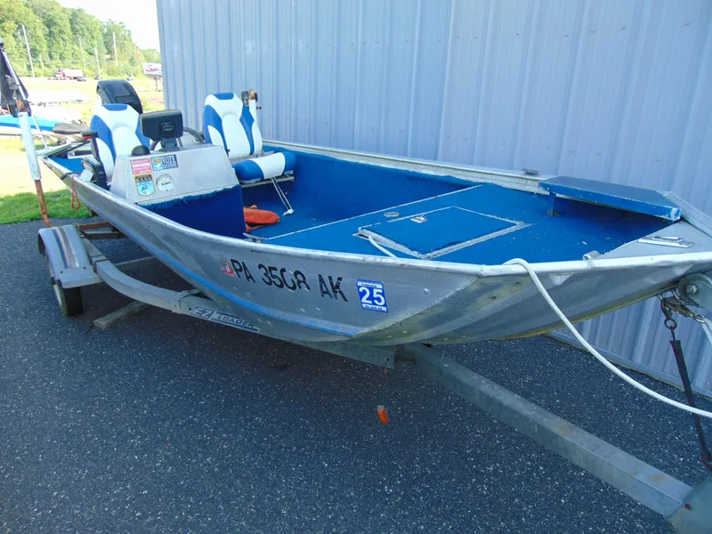 Slide: The Image of 1985 Fisher Hawk 3V boat on trailer, blue and white interior. - 1