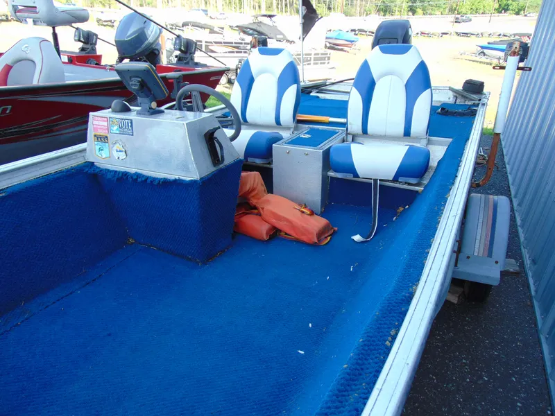 Slide: The Image of 1985 Fisher Hawk 3V boat with blue seats and steering console. - 10