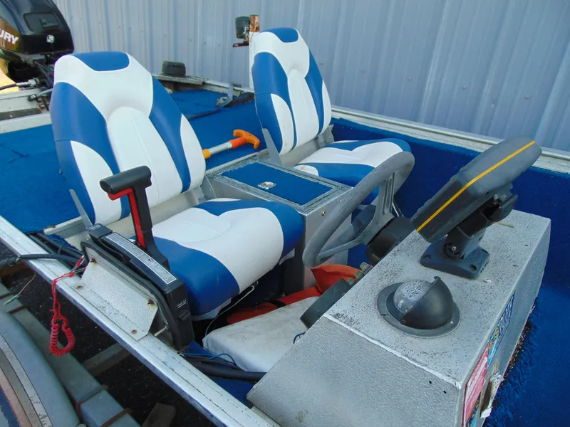 Slide: The Image of 1985 Fisher Hawk 3V boat interior with blue and white seats. - 2