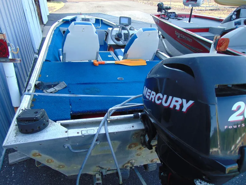 Slide: The Image of 1985 Fisher Hawk 3V boat with Mercury engine, blue seats. - 5
