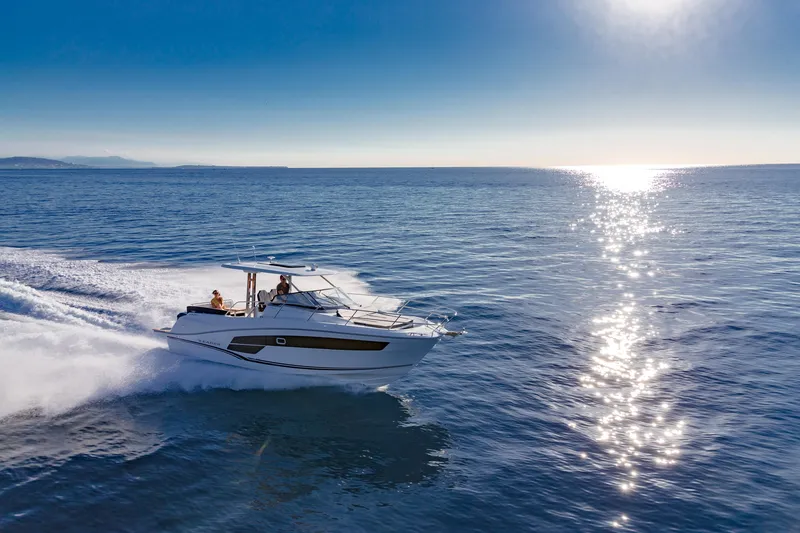 Slide: The Image of 2026 Jeanneau Leader 10.5 WA cruising on open sea under clear blue sky. - 4
