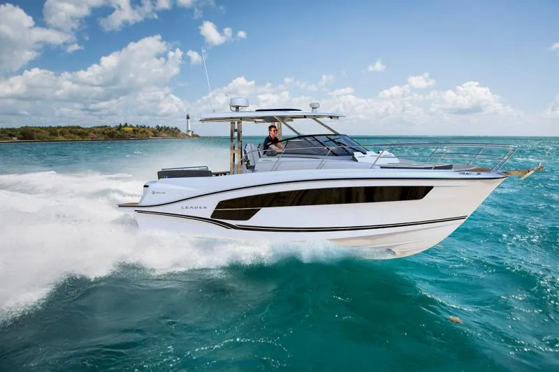 The Image of 2026 Jeanneau Leader 10.5 WA cruising on turquoise waters under a clear sky. - 0