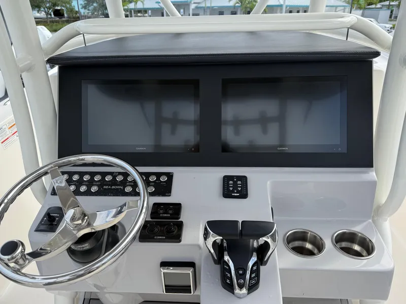 Slide: The Image of 2025 Sea Born SX281 boat dashboard with dual screens and steering wheel. - 10