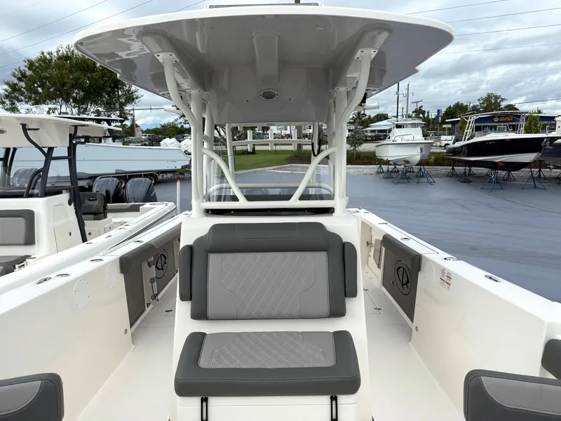 Slide: The Image of 2025 Sea Born SX281 boat with seating and canopy, displayed at a marina. - 11