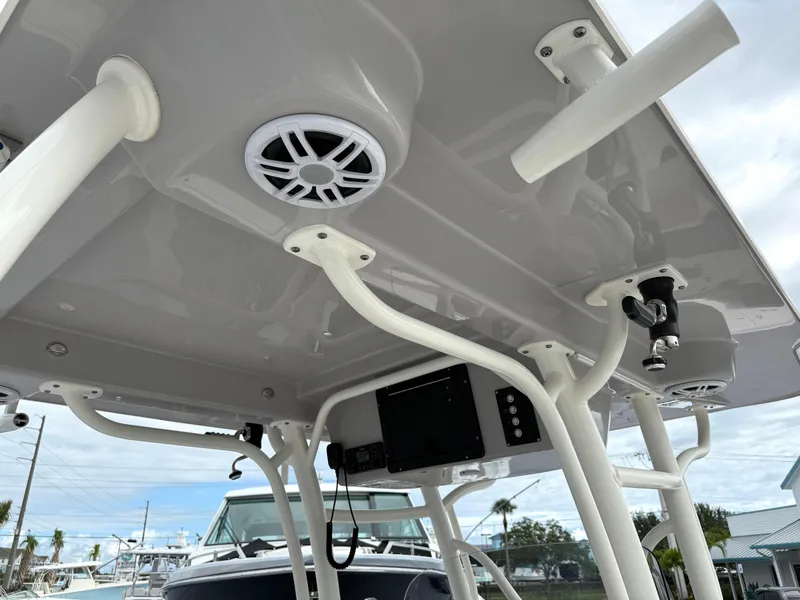 Slide: The Image of 2025 Sea Born SX281 boat T-top with speakers and rod holders. - 13