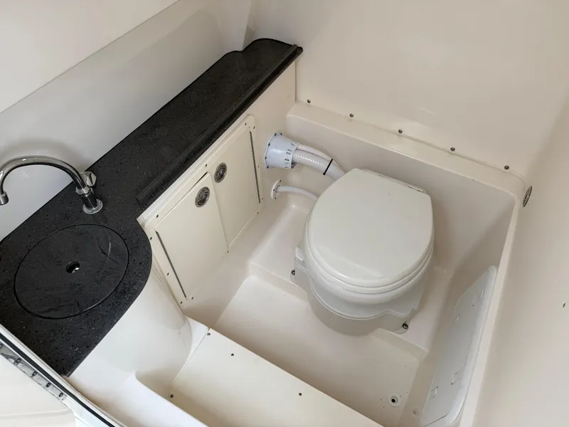 Slide: The Image of Compact bathroom in 2025 Sea Born SX281 boat with toilet and sink. - 16