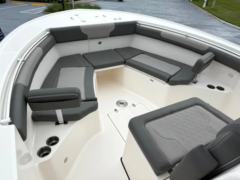 Slide: The Image of 2025 Sea Born SX281 boat interior with gray cushioned seating and cup holders. - 18