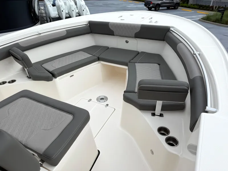 Slide: The Image of 2025 Sea Born SX281 boat interior with gray cushioned seating and cup holders. - 19