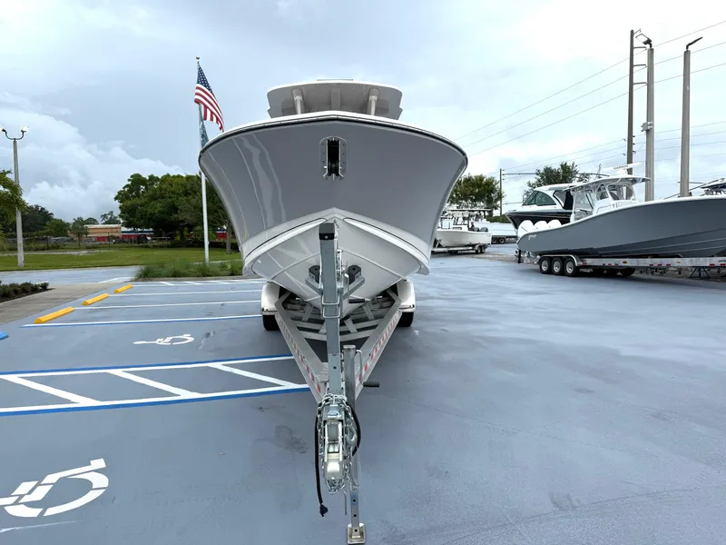 Slide: The Image of 2025 Sea Born SX281 boat on trailer in parking lot, front view. - 2