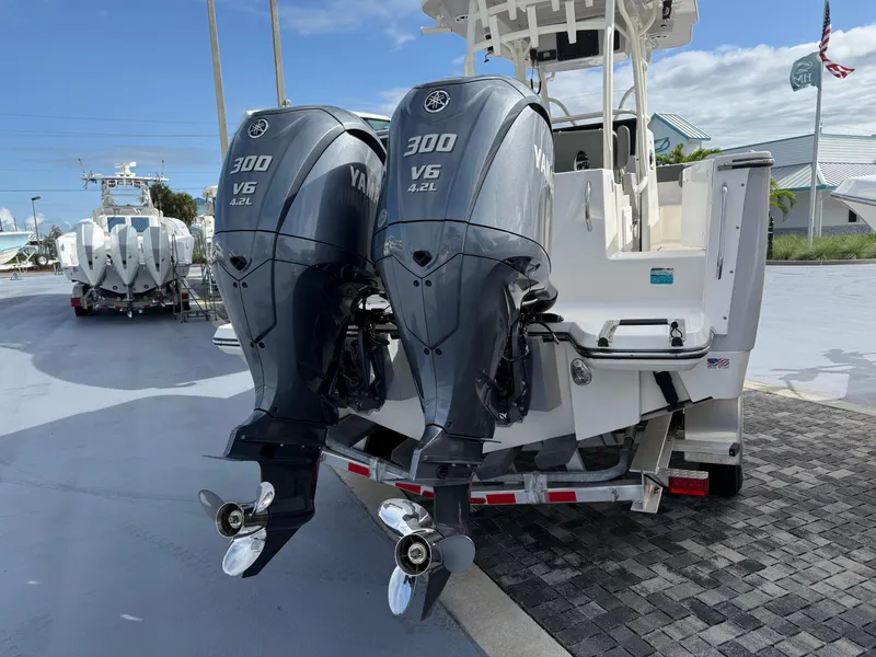 Slide: The Image of 2025 Sea Born SX281 boat with dual Yamaha 300 V6 outboard engines, docked outdoors. - 22