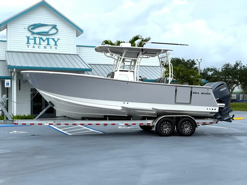Slide: The Image of 2025 Sea Born SX281 boat on trailer outside HMY Yachts building. - 27