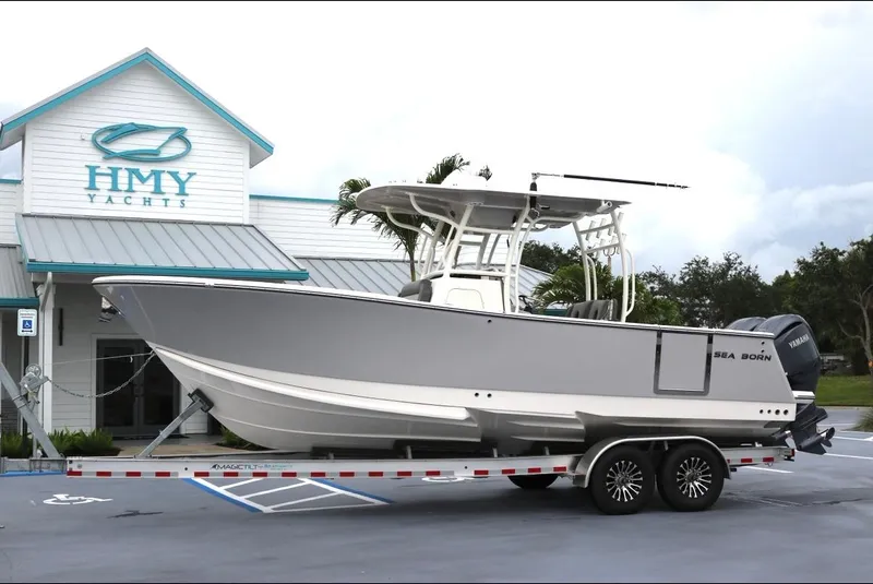 Slide: The Image of 2025 Sea Born SX281 boat on trailer outside HMY Yachts building. - 28