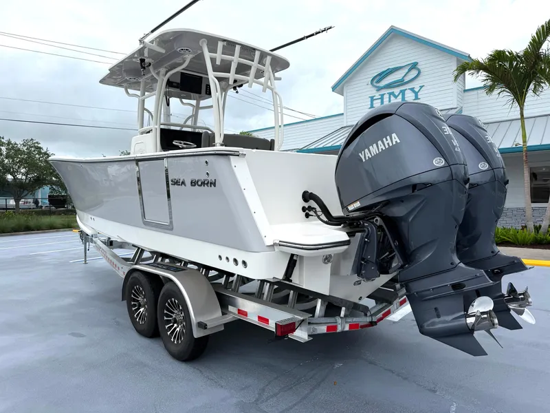 Slide: The Image of 2025 Sea Born SX281 boat with dual Yamaha engines on a trailer. - 4