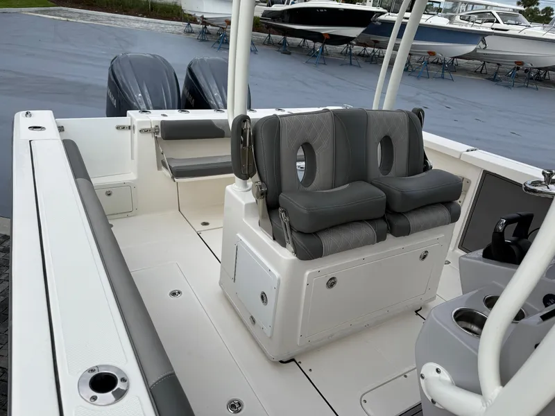 Slide: The Image of 2025 Sea Born SX281 boat interior with dual engines and cushioned seating. - 9