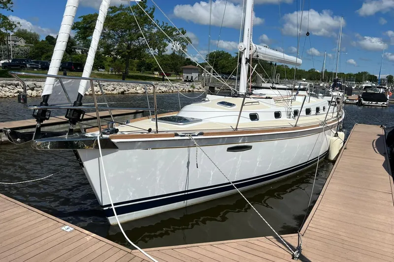Slide: The Image of 2025 Tartan 395 sailboat docked in a marina under a clear blue sky. - 0