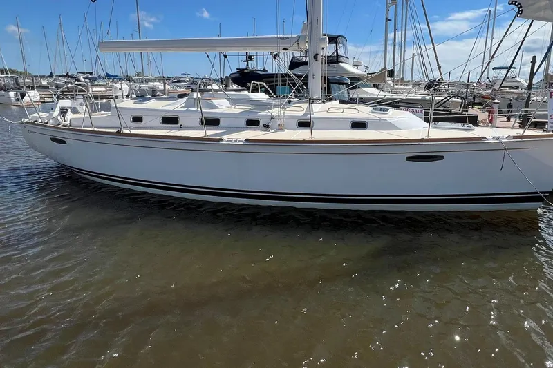 Slide: The Image of 2025 Tartan 395 sailboat docked in a marina under a clear blue sky. - 1