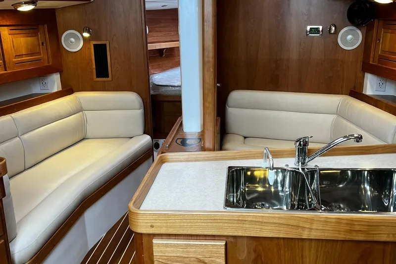 Slide: The Image of Interior of 2025 Tartan 395 yacht with modern seating and kitchen area. - 10