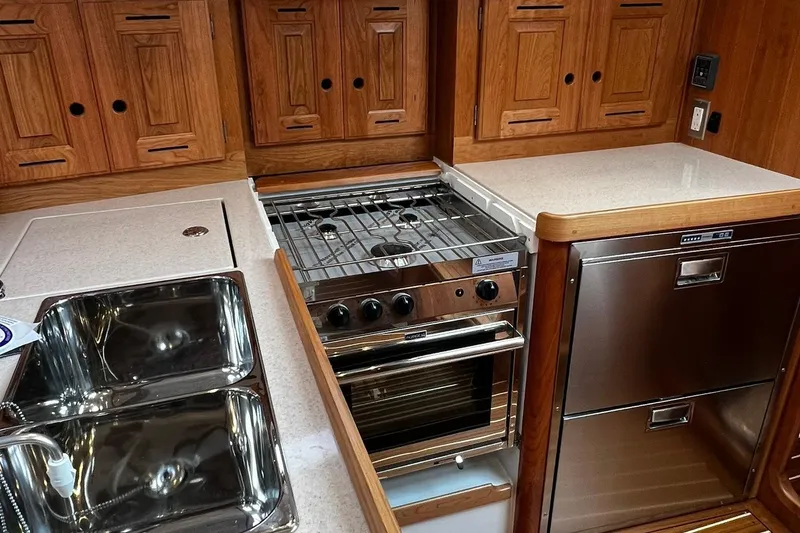 Slide: The Image of Modern kitchen in 2025 Tartan 395 yacht with stove, sink, and wooden cabinetry. - 11