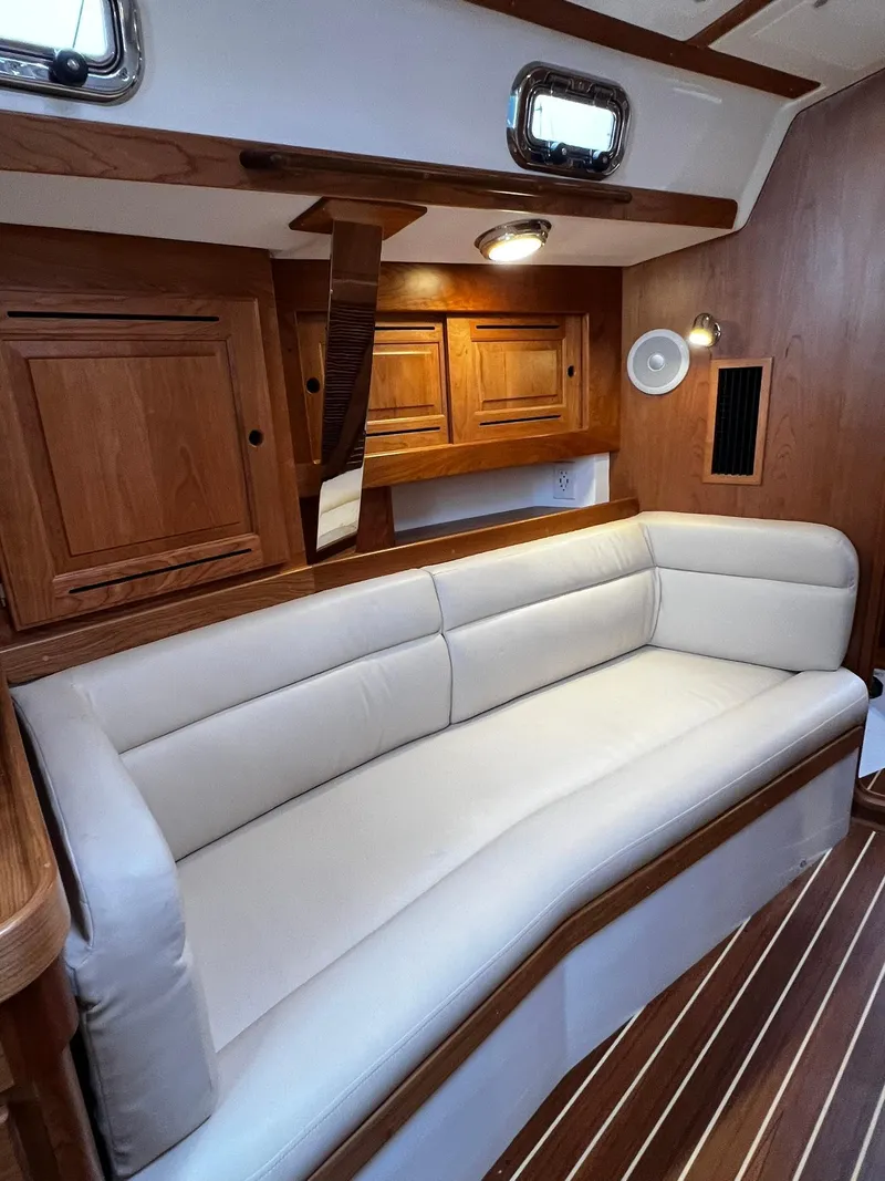 Slide: The Image of Luxurious interior of 2025 Tartan 395 yacht with elegant wood finish and plush seating. - 15