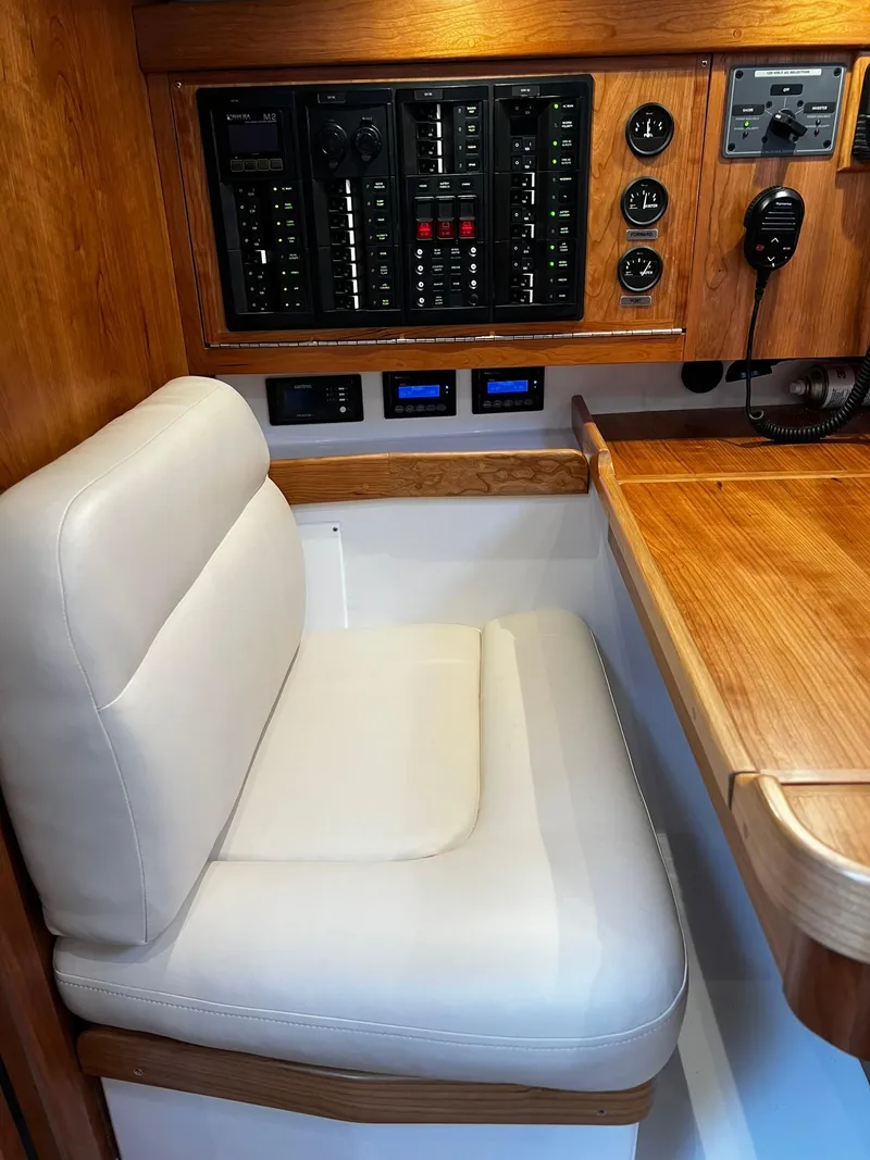 Slide: The Image of Interior of 2025 Tartan 395 yacht with control panel and cushioned seating. - 16