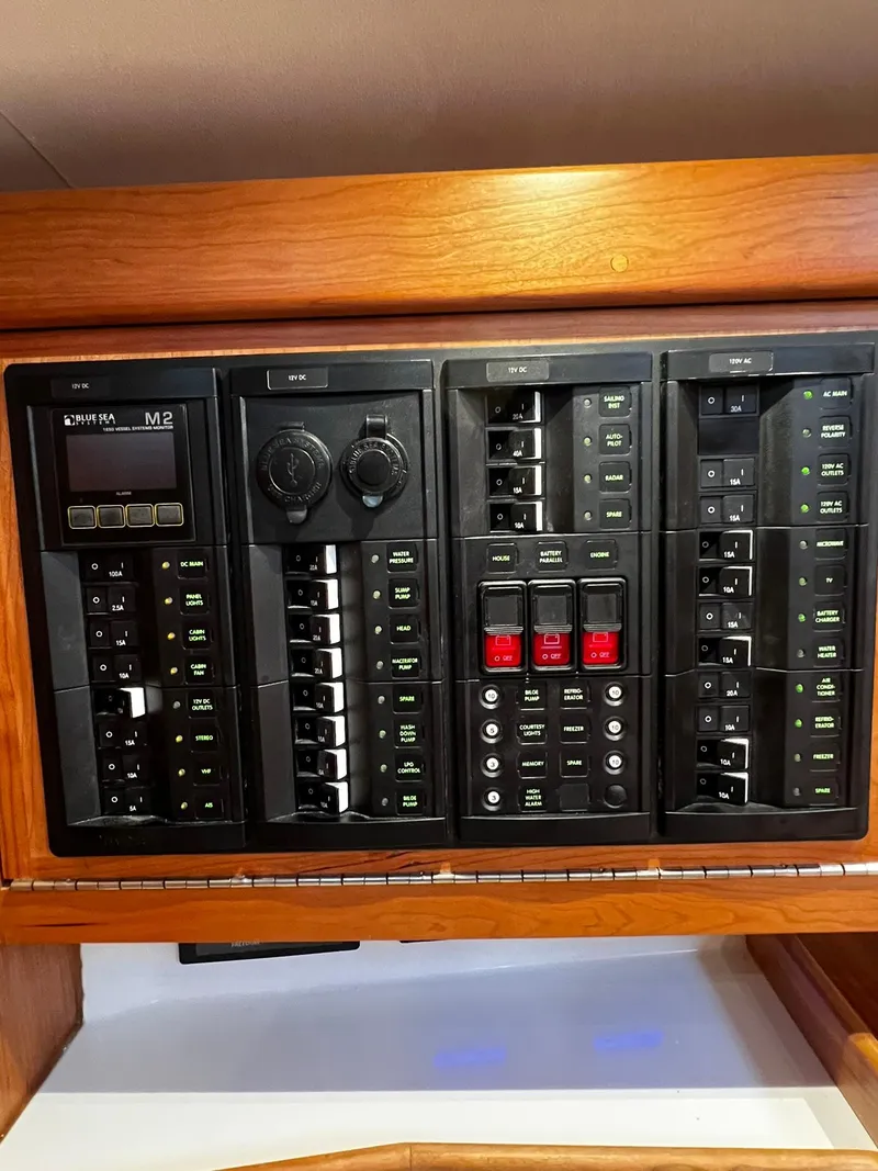 Slide: The Image of Control panel of a 2025 Tartan 395 yacht with various switches and dials. - 17