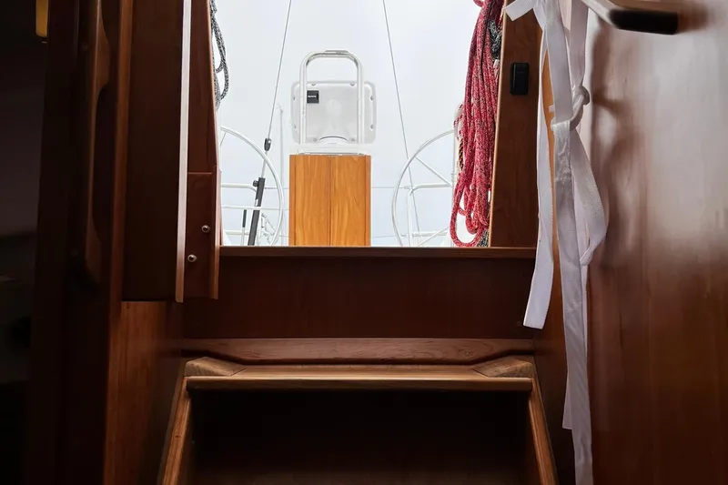 Slide: The Image of Interior view of 2025 Tartan 395 sailboat, showcasing wooden steps and cockpit entrance. - 18