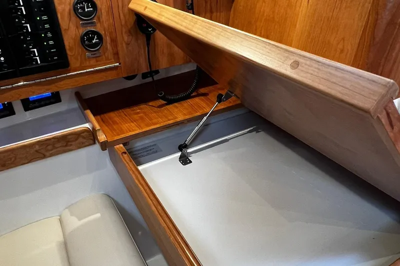 Slide: The Image of Tartan 395 (2025) interior with wooden cabinetry and storage compartment. - 19