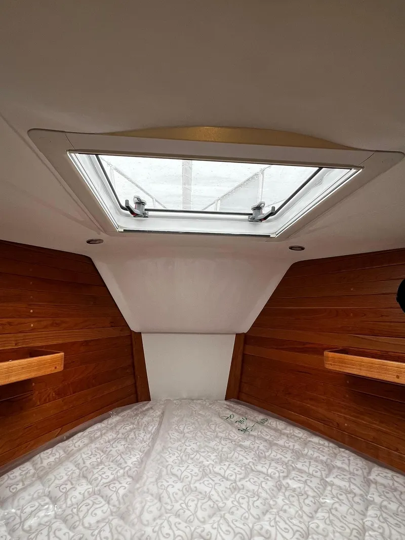 Slide: The Image of Interior cabin of 2025 Tartan 395 yacht with wooden paneling and skylight. - 21