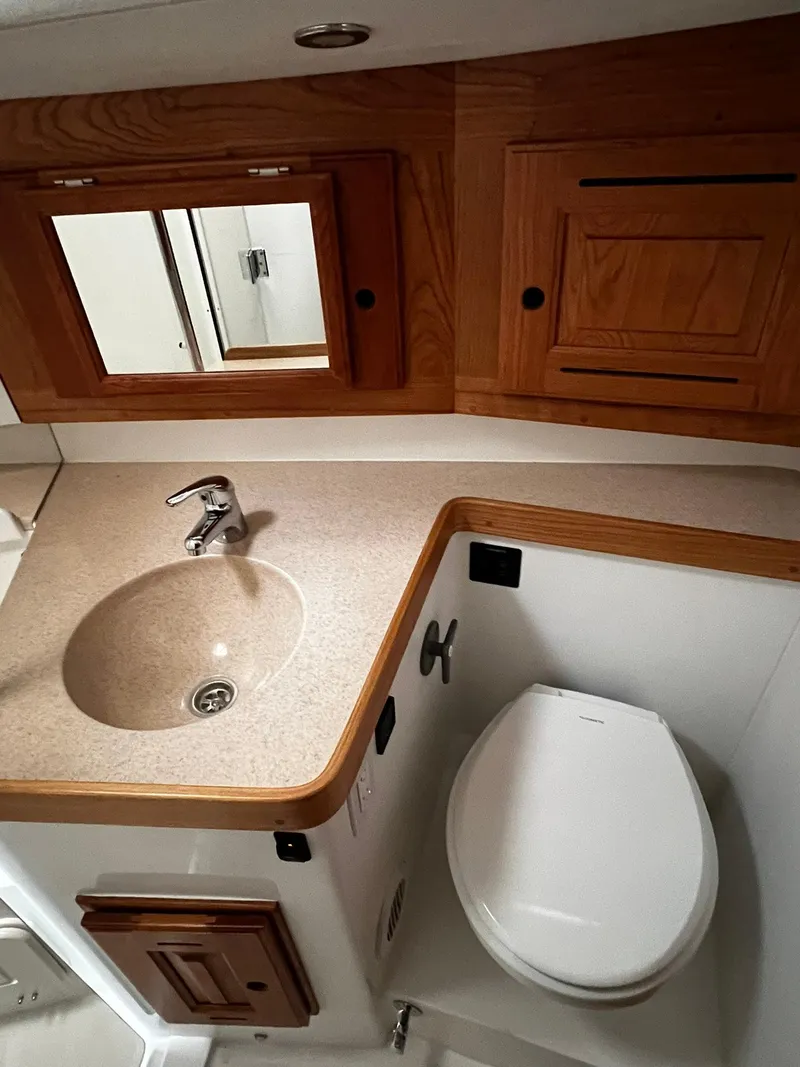 Slide: The Image of Compact bathroom in 2025 Tartan 395 yacht with sink, toilet, and wooden cabinetry. - 27
