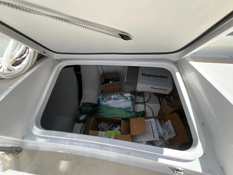 Slide: The Image of Open storage compartment on 2025 Tartan 395 yacht with Raymarine equipment and supplies. - 28
