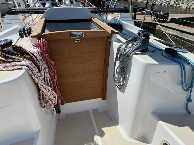 Slide: The Image of 2025 Tartan 395 sailboat cockpit with ropes and wooden hatch. - 6