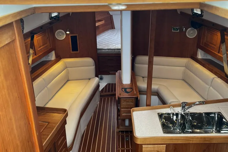 Slide: The Image of Luxurious interior of 2025 Tartan 395 yacht with elegant wood finish and plush seating. - 7