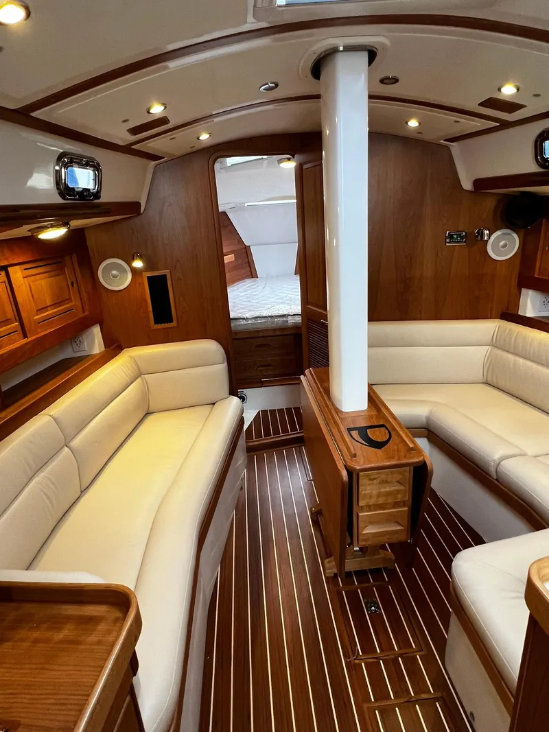 Slide: The Image of Luxurious interior of 2025 Tartan 395 yacht with elegant wood finish and plush seating. - 8