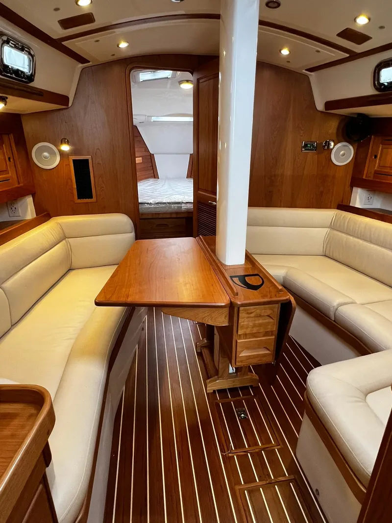 Slide: The Image of Luxurious interior of 2025 Tartan 395 yacht with elegant wood finish and plush seating. - 9