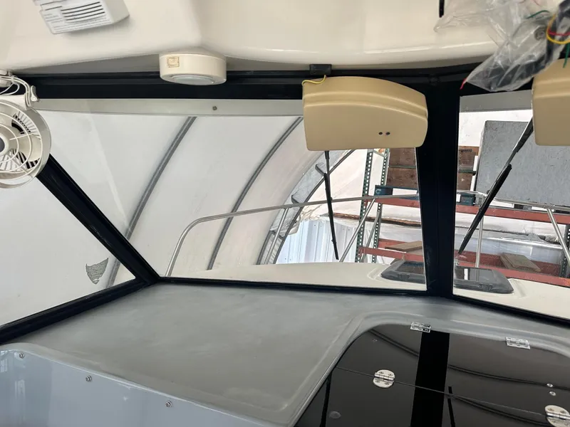 Slide: The Image of 2004 Trophy 2359 Hardtop boat stern with propeller and trim tabs visible. - 10