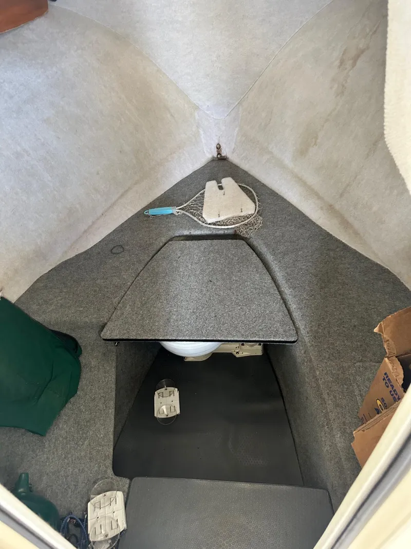 Slide: The Image of 2004 Trophy 2359 Hardtop boat interior with white seating and green canopy. - 12