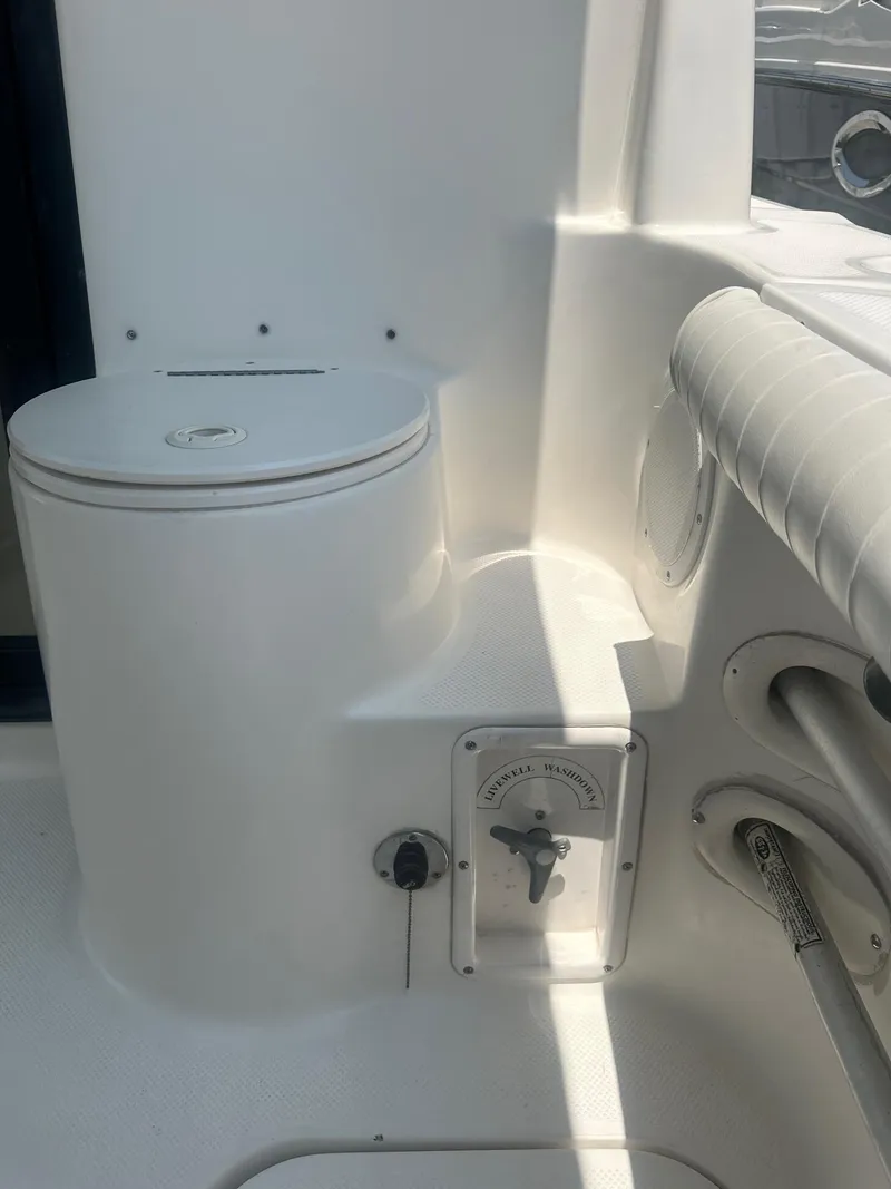 Slide: The Image of 2004 Trophy 2359 Hardtop interior with a sleek table setup. - 13