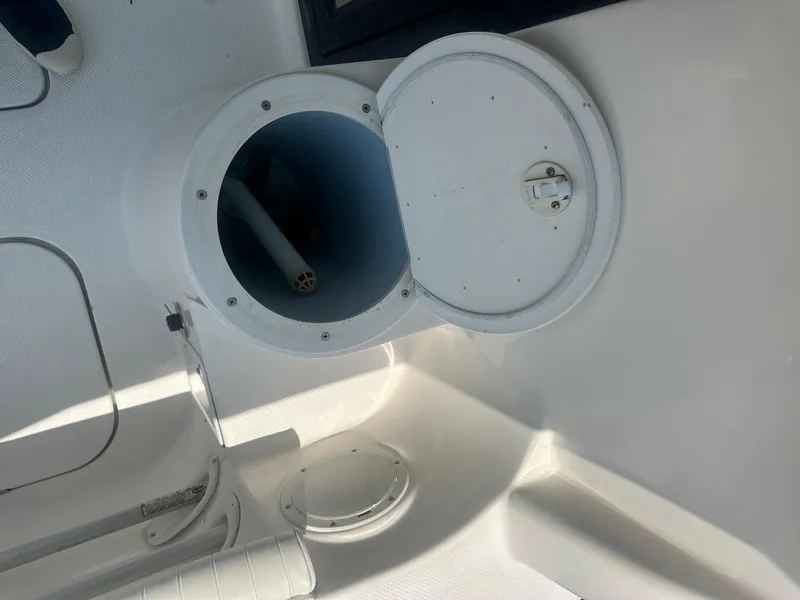 Slide: The Image of 2004 Trophy 2359 Hardtop interior with dashboard and windows in a covered area. - 15