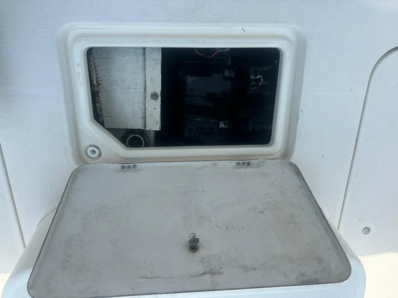 Slide: The Image of 2004 Trophy 2359 Hardtop boat dashboard with steering wheel and control gauges. - 16