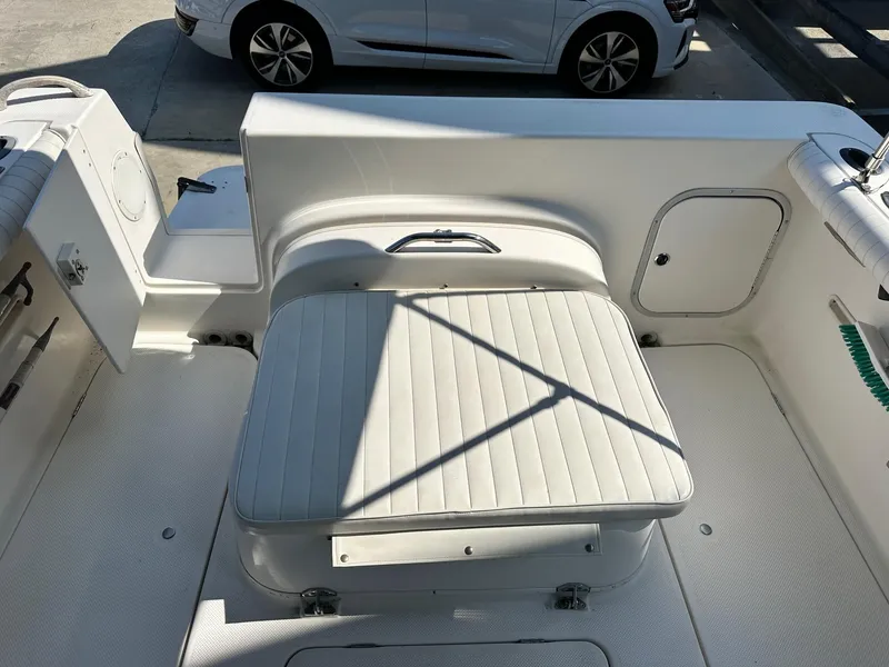 Slide: The Image of 2004 Trophy 2359 Hardtop boat interior with rod holders and storage compartment. - 32