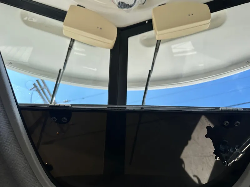 Slide: The Image of Interior of a 2004 Trophy 2359 Hardtop boat with white seating and windows. - 33