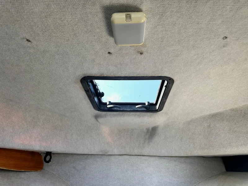 Slide: The Image of 2004 Trophy 2359 Hardtop boat interior with steering wheel and sink. - 34