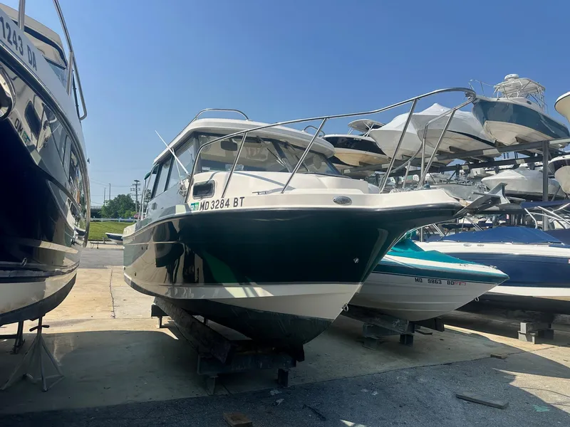Slide: The Image of 2004 Trophy 2359 Hardtop boat on trailer in parking lot, sunny day. - 4