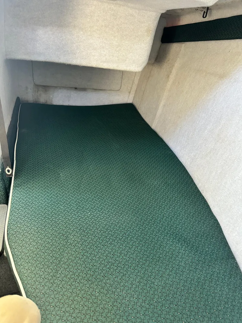 Slide: The Image of 2004 Trophy 2359 Hardtop cabin interior with green carpet flooring. - 43