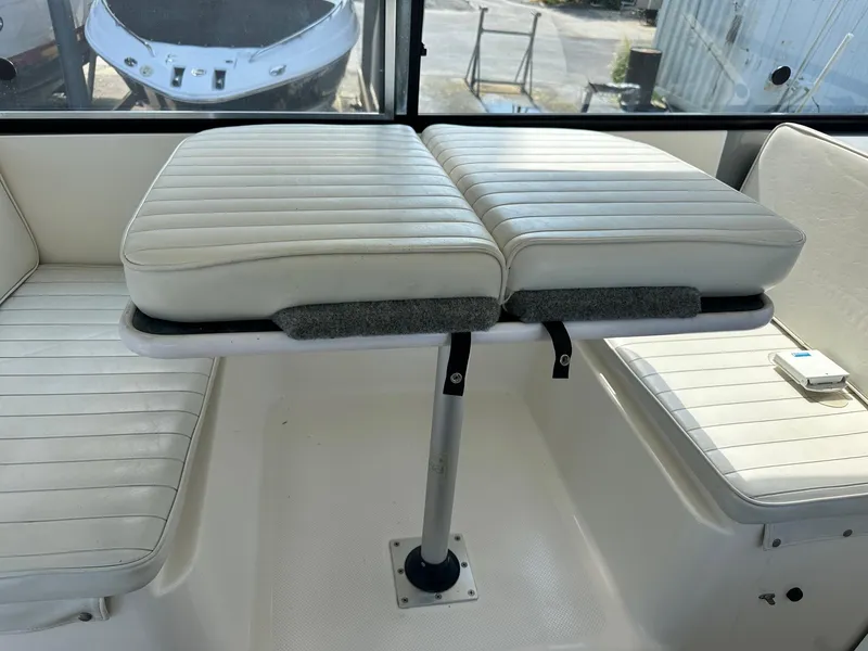 Slide: The Image of 2004 Trophy 2359 Hardtop boat interior with white cushioned seating. - 45